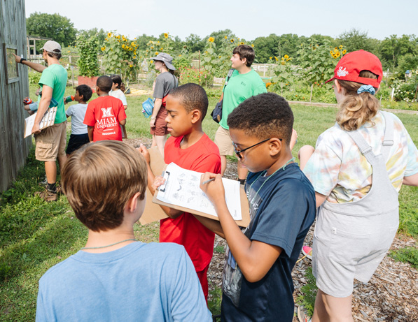 a group of children standing in a field
