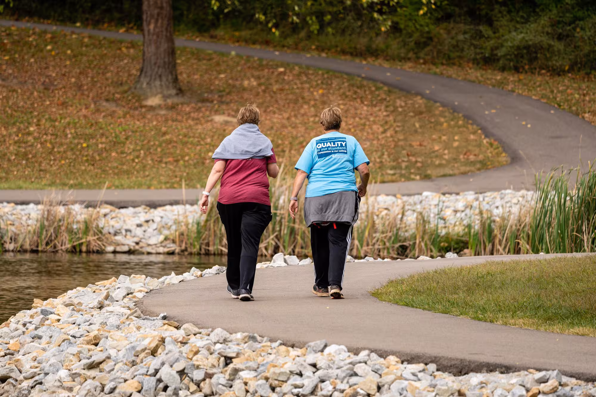two women walking on a path