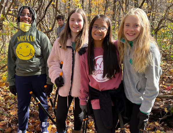 a group of girls standing in a forest