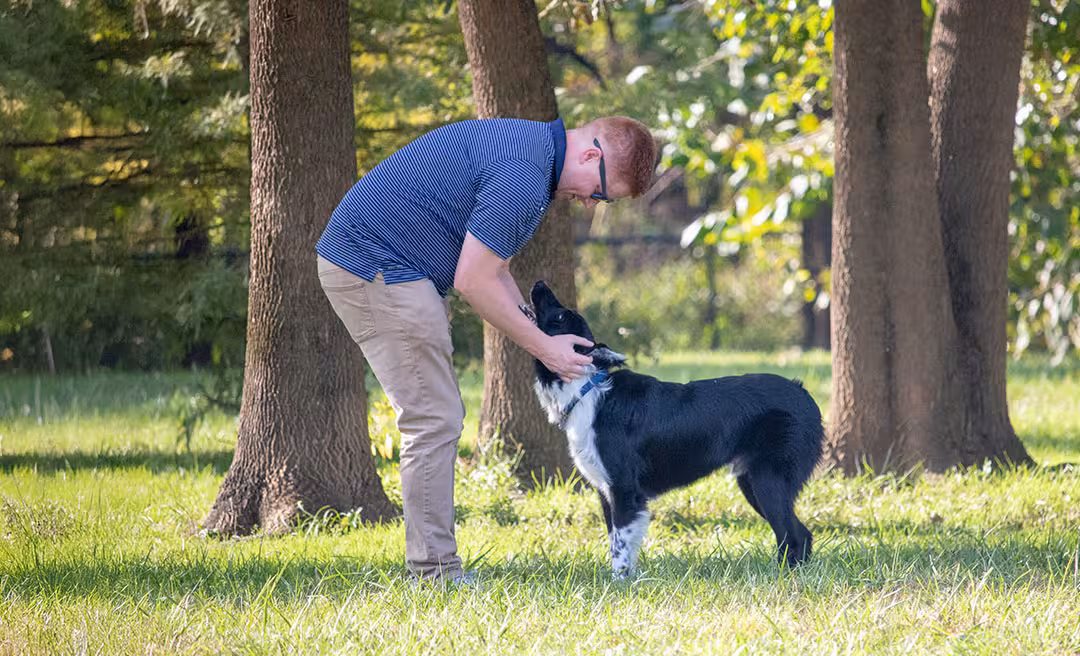 a man petting a dog
