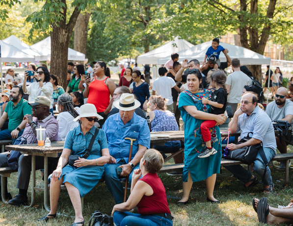 a group of people sitting on picnic tables
