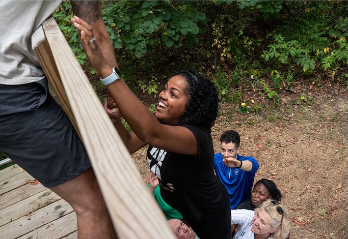 team building exercise climbing a wall