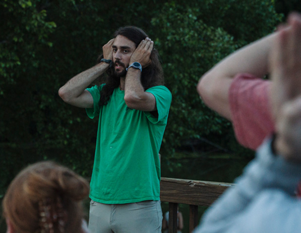 a man with his hands on his ears