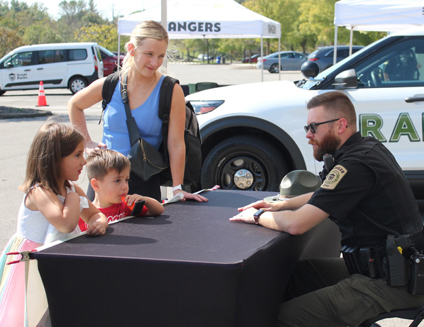 a police officer talking to a group of kids
