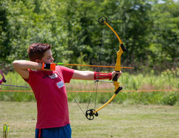 a boy holding a bow and arrow