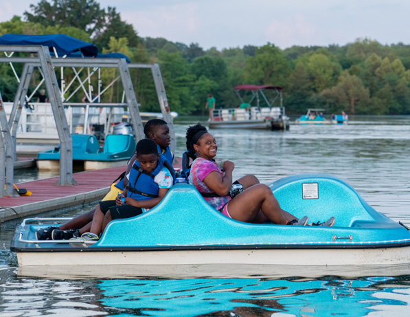 a group of people on a pedal boat