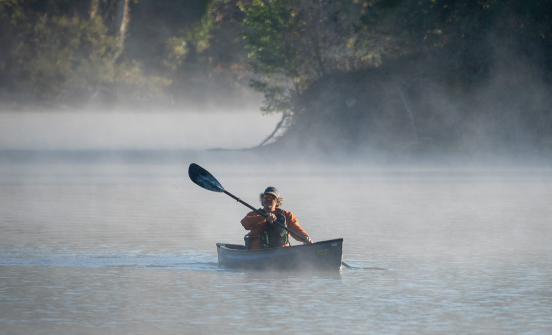 a person in a boat on a lake