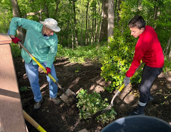 two men digging in the ground