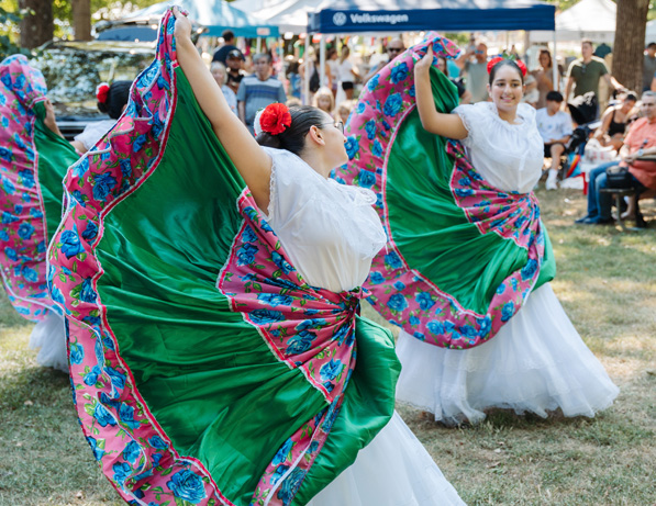 a group of women dancing in a field