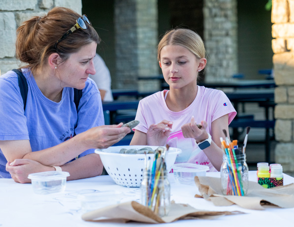 a woman and a girl sitting at a table
