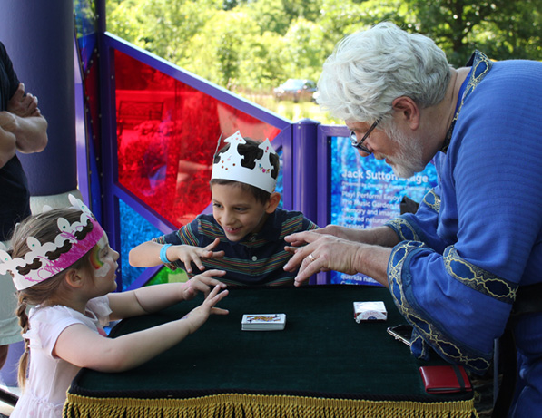 a man and two children playing cards