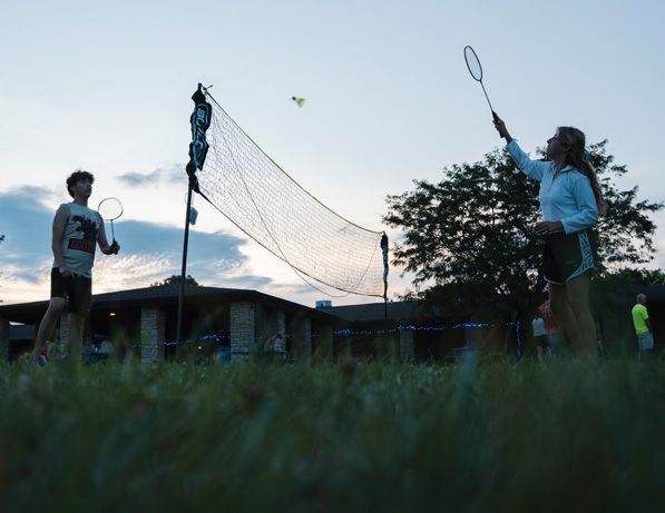 a couple of people playing badminton